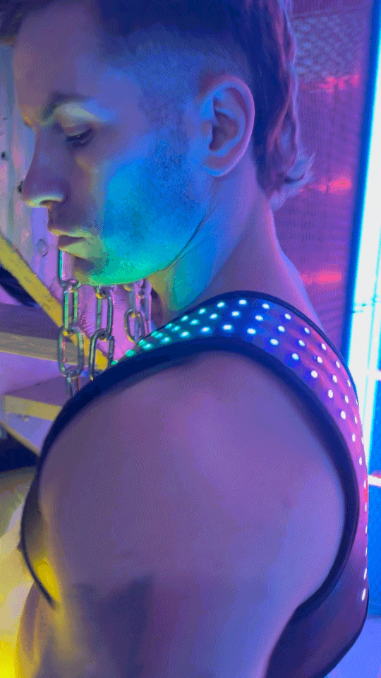 Soundwave synergy harness black shoulder-strapped garment with glowing blue led light pattern visible from back side
