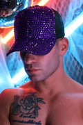 A purple spark trucker hat with dazzling crystal-encrusted design, black brim, and adjustable strap