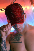 A red spark trucker hat featuring sparkling rhinestones for stylish casual wear