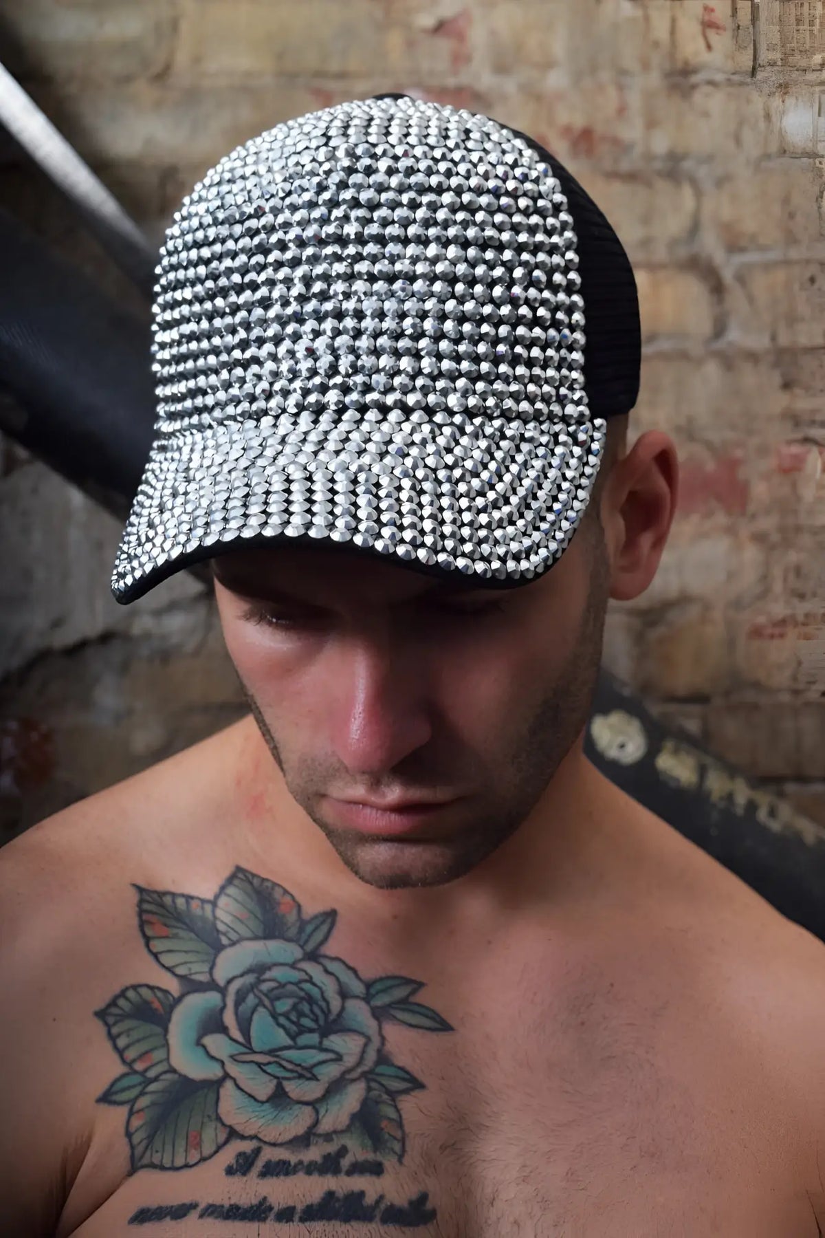 A black and silver rhinestone-embellished spark trucker hat with mesh back for stylish casual wear