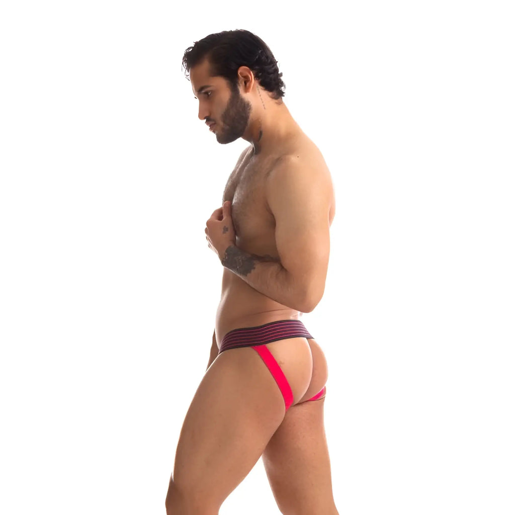 The man is wearing a vibrant red and purple striped Sport Fucker Rally jockstrap with a supportive contoured design