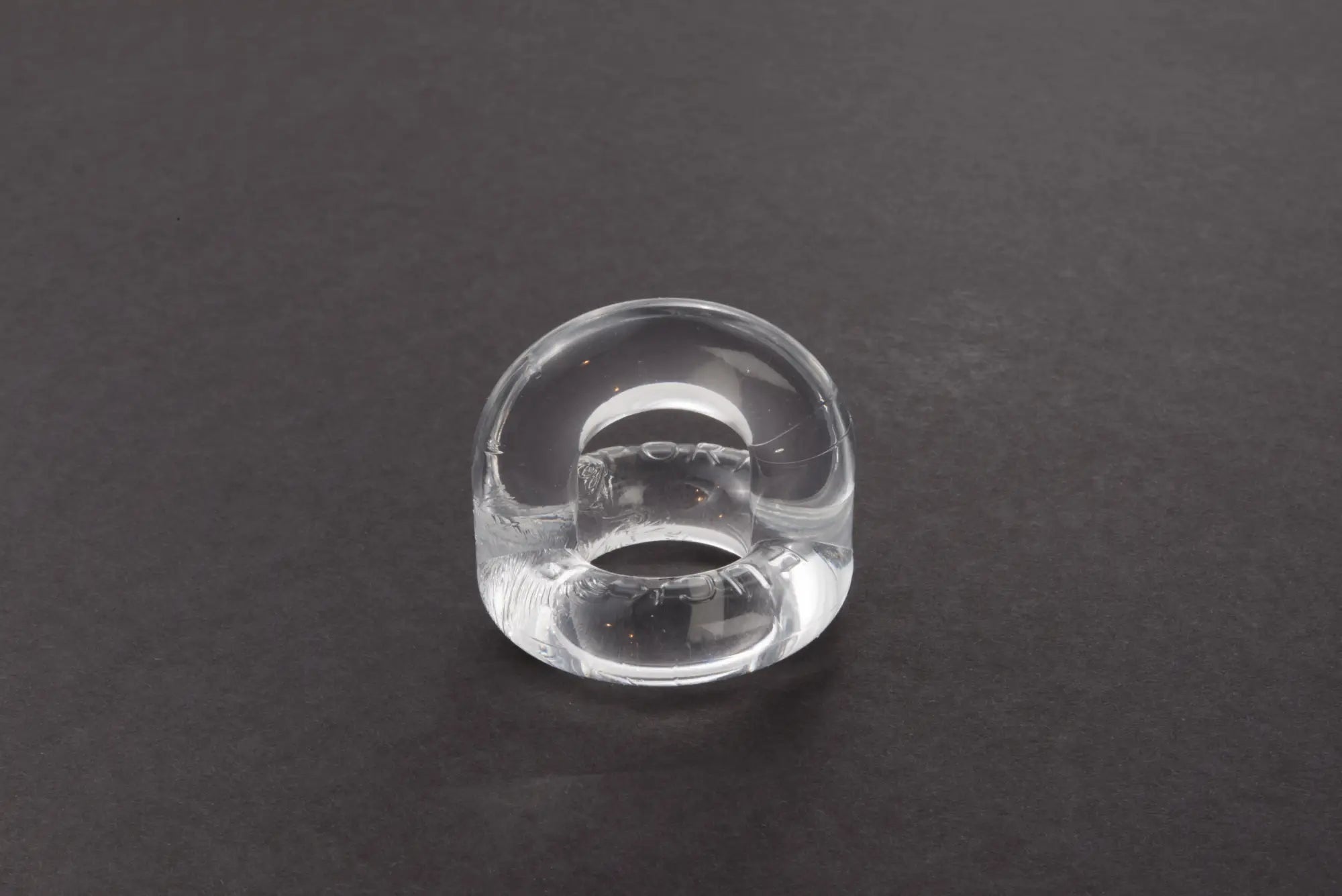 Clear glass sport fucker universal cockring with smooth rounded design and subtle internal reflections