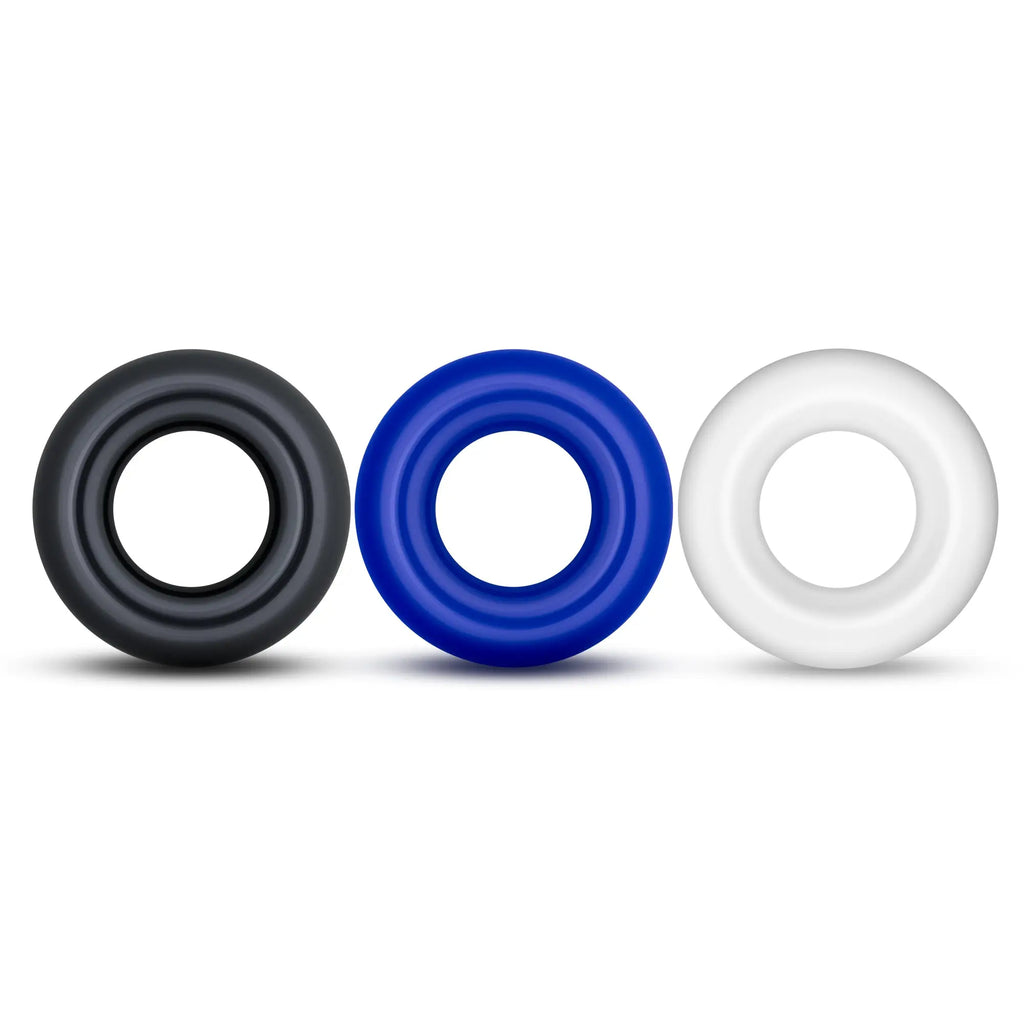 Three silicone Stay Hard Stay Hard Donut Rings in black blue and white designed for comfort and durability