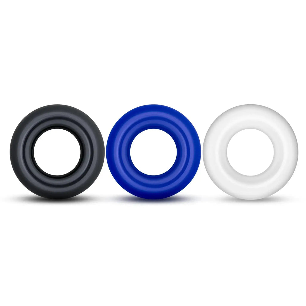 Three silicone Stay Hard Stay Hard Donut Rings in black blue and white designed for comfort and durability