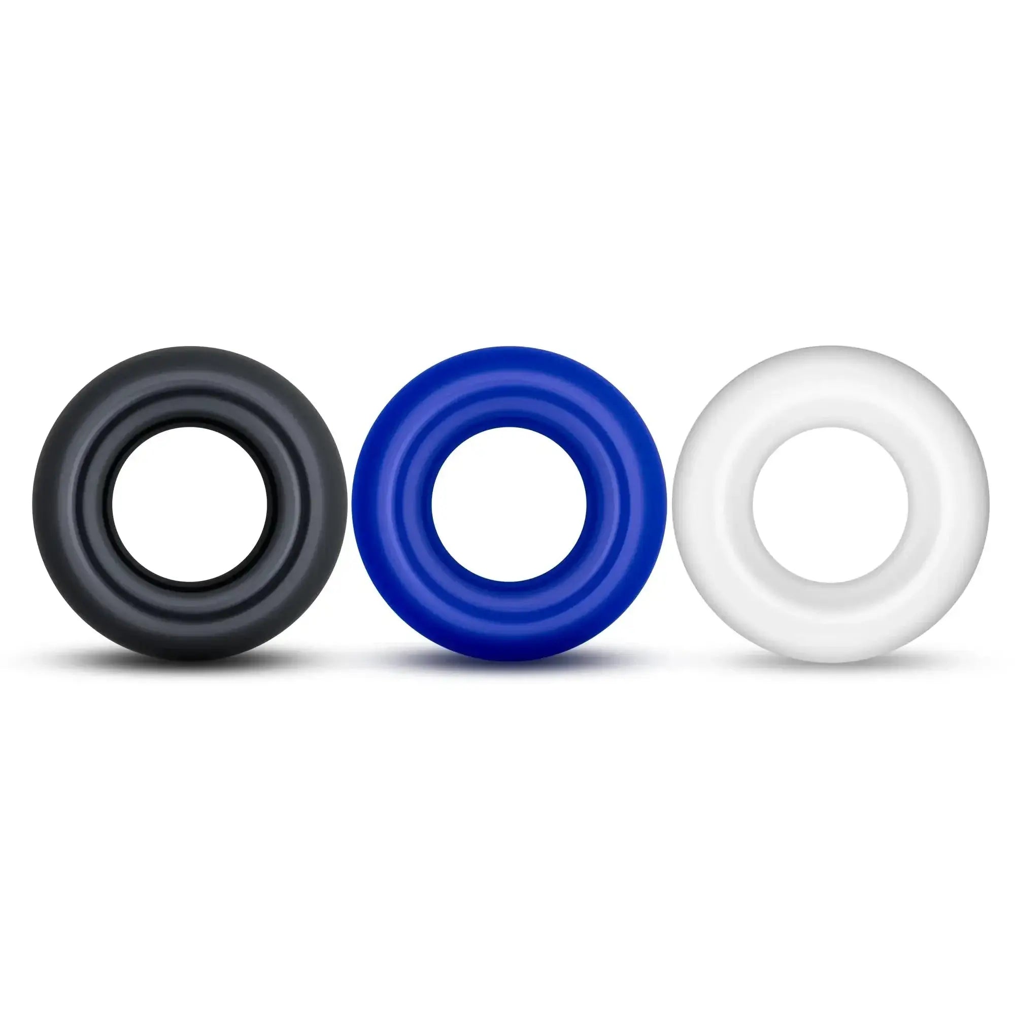 Three silicone Stay Hard Stay Hard Donut Rings in black blue and white designed for comfort and durability