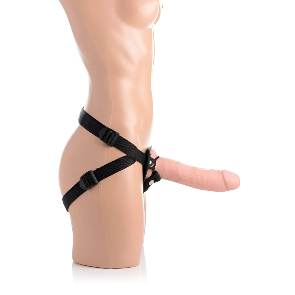 Black adjustable harness with central clasp securing a pink 8 inch silicone dildo from strap u brazen collection