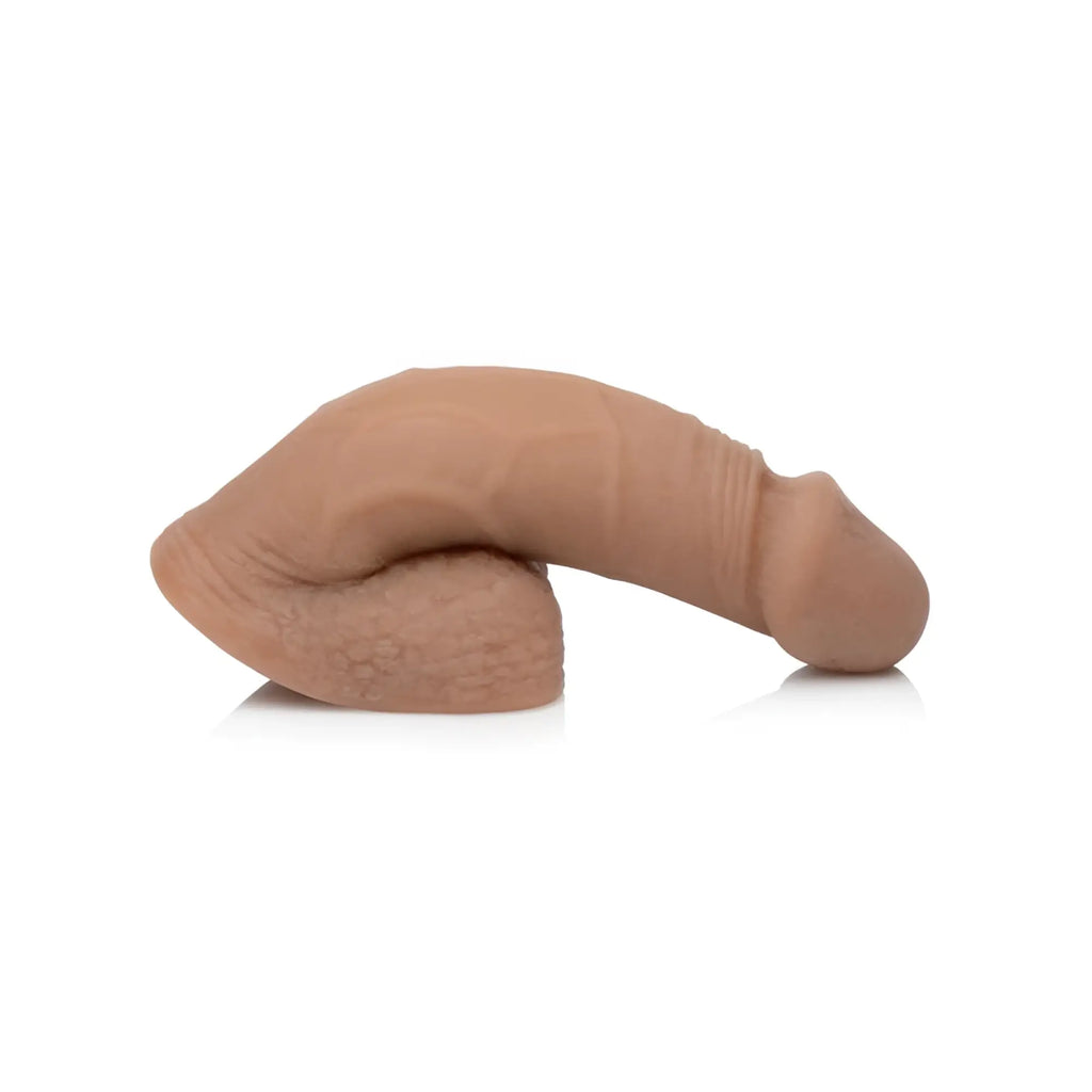 Beige silicone realistic male genital model with textured surface and rounded contours for strap u large bulge soft packer dildo medium skin tone