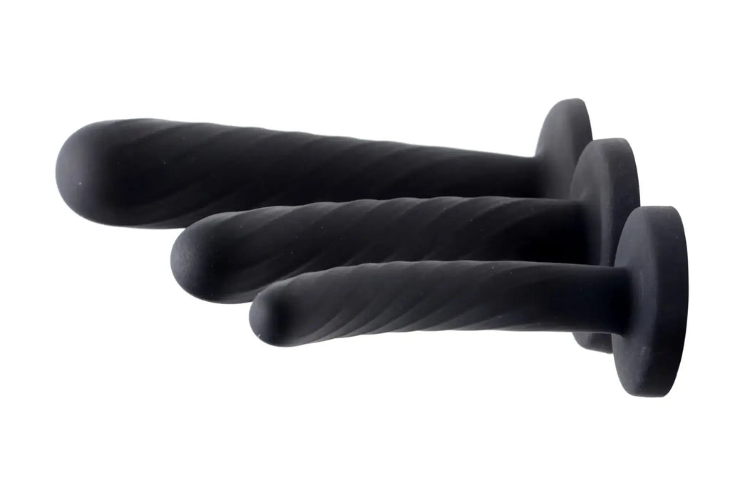 Set of three black silicone anal plugs with textured twisted surfaces and rounded tips from strap u trinity dildo set