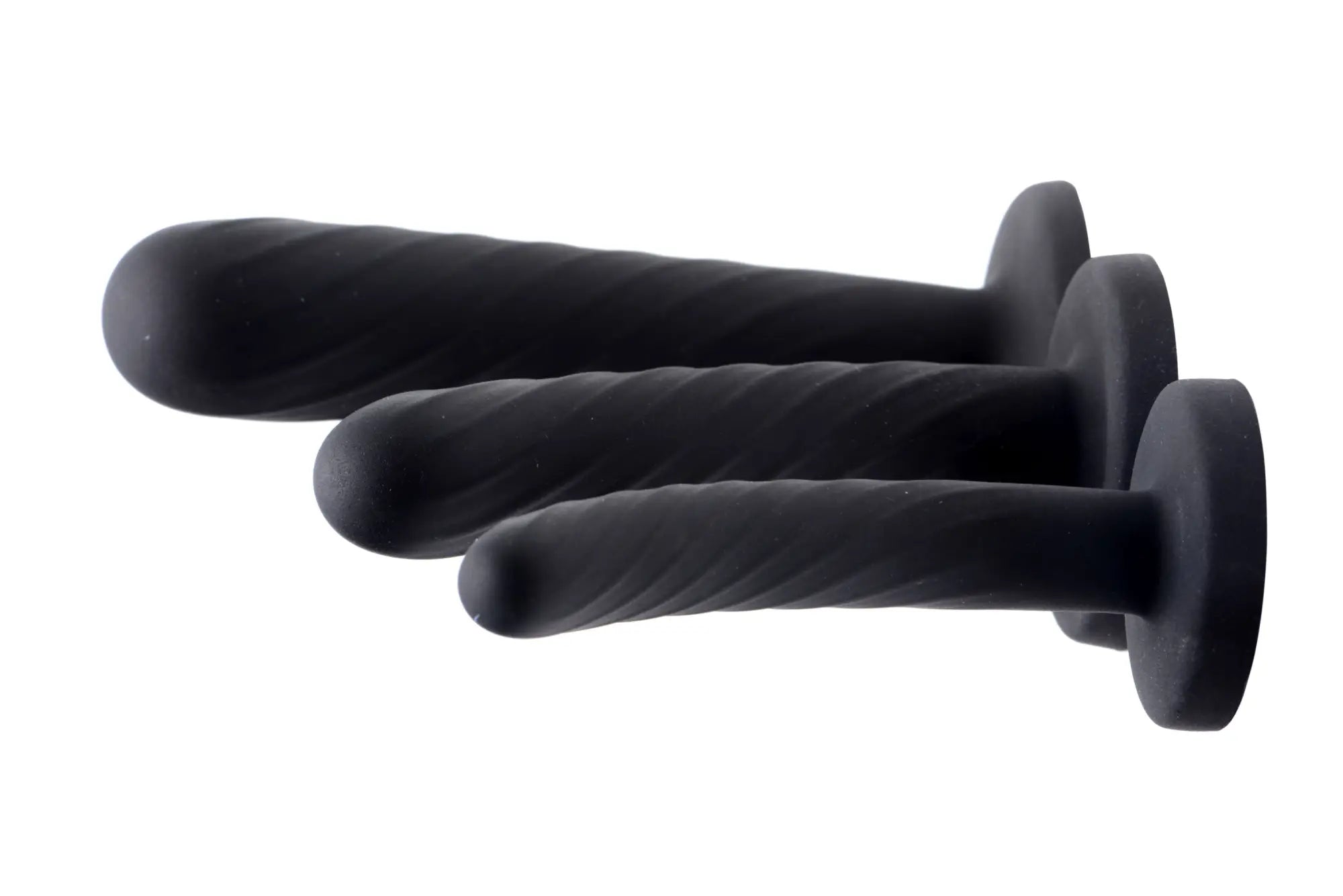 Set of three black silicone anal plugs with textured twisted surfaces and rounded tips from strap u trinity dildo set