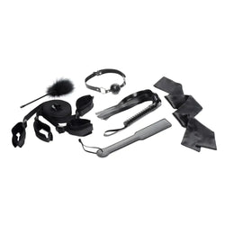 Black leather bondage kit with assorted restraints whip and accessories for strict bed restraint play