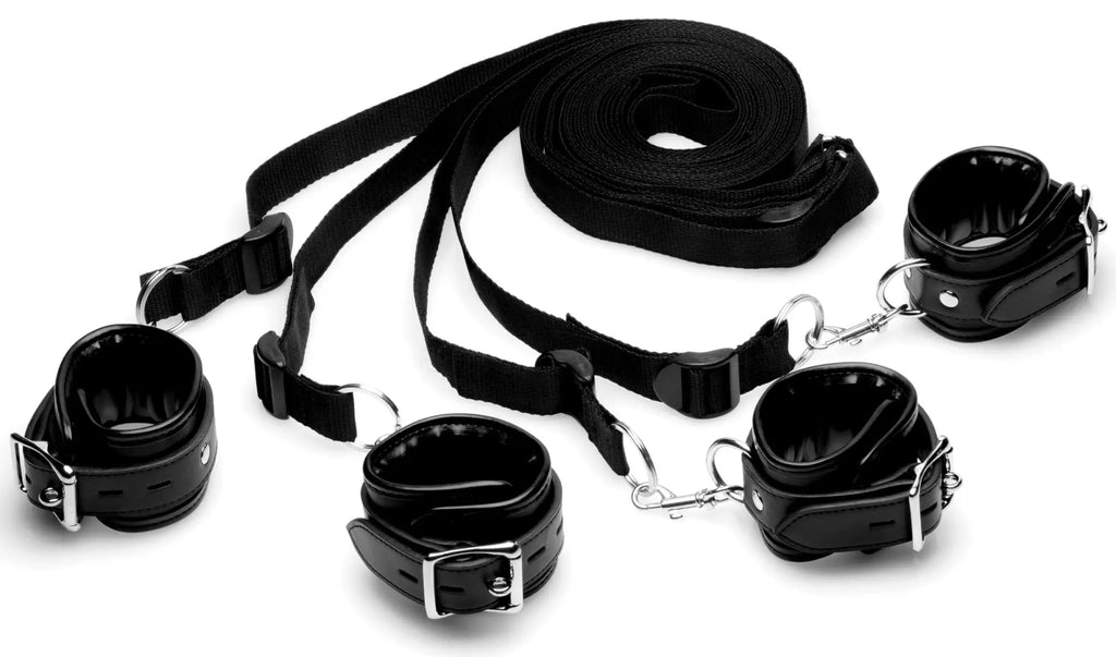 Black leather strict bed restraint kit with adjustable straps and metal buckles for bondage use