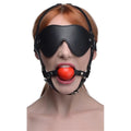 Black leather muzzle with red ball gag designed as a strict blindfold harness for restraint and sensory play