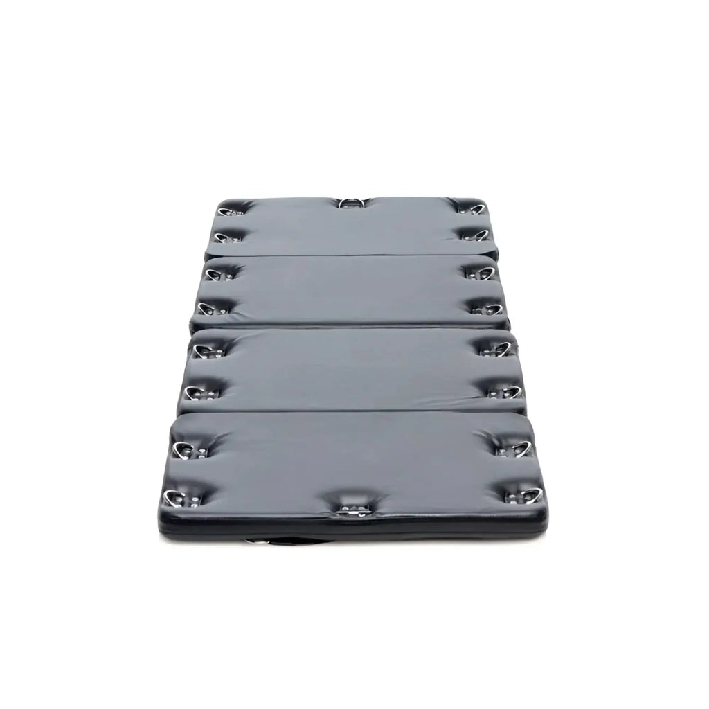 Black padded folding mat with silver metal d rings along edges for strict bondage board black xl use