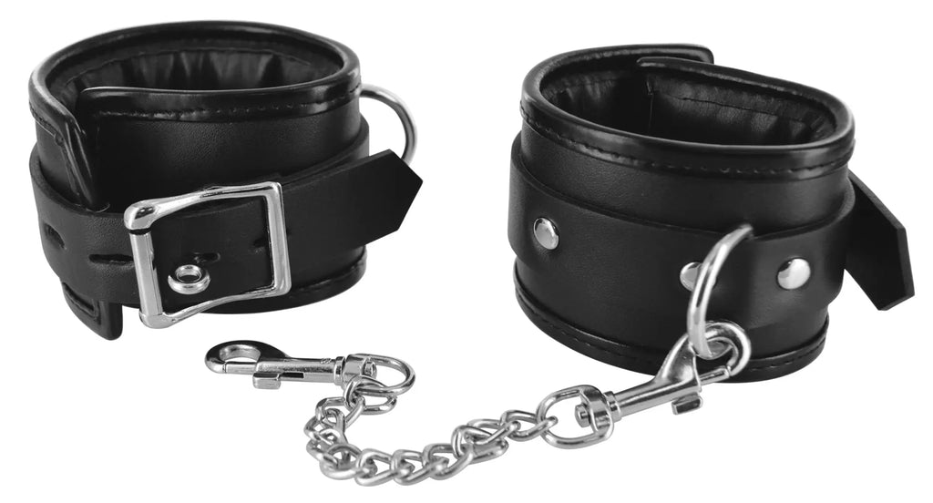 Black leather strict locking padded wrist cuffs with silver buckles and connecting chain for secure restraint