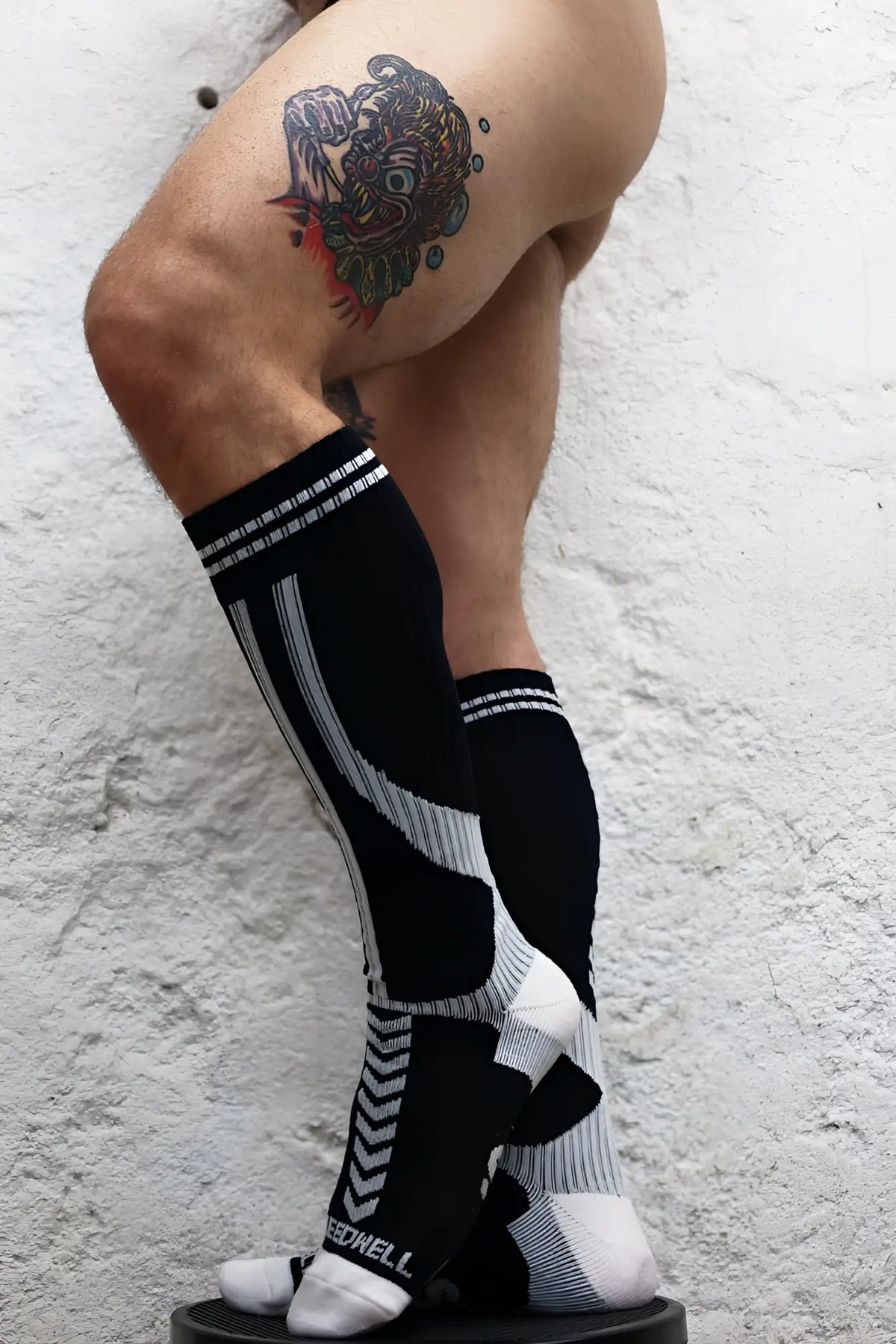 Black and white athletic compression socks with geometric pattern and speedhill branding on the ankle for performance