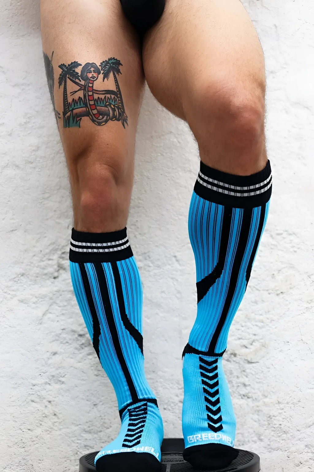 Bright blue and black striped Sucker Socks compression socks with a sleek athletic design for improved performance