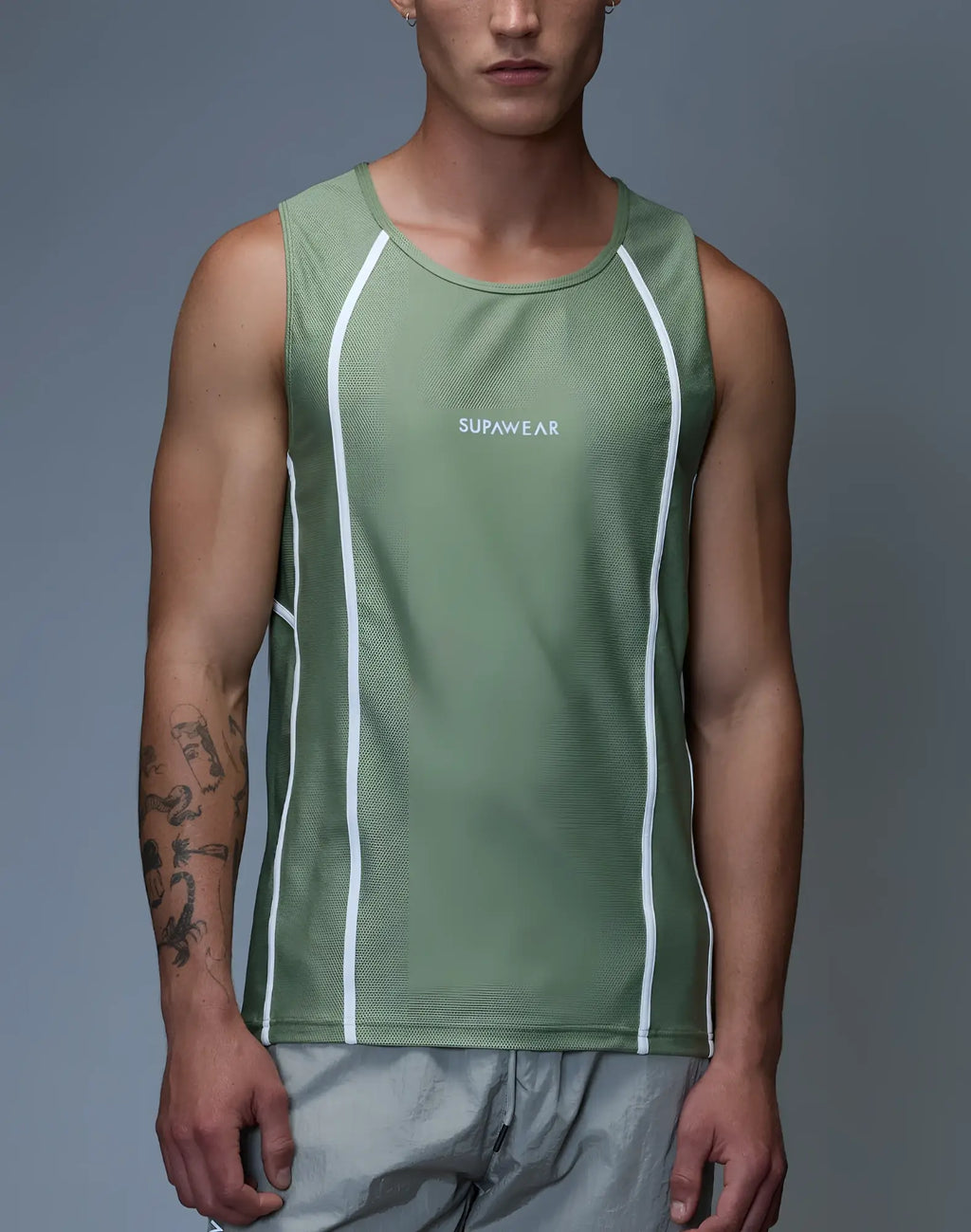A men’s olive green supawear airflow singlet with white vertical stripes and a subtle logo on the chest