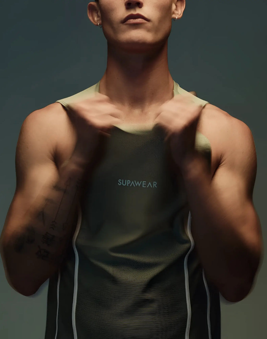 Olive green Supawear Airflow singlet tank top with white side panels and subtle chest logo for activewear use