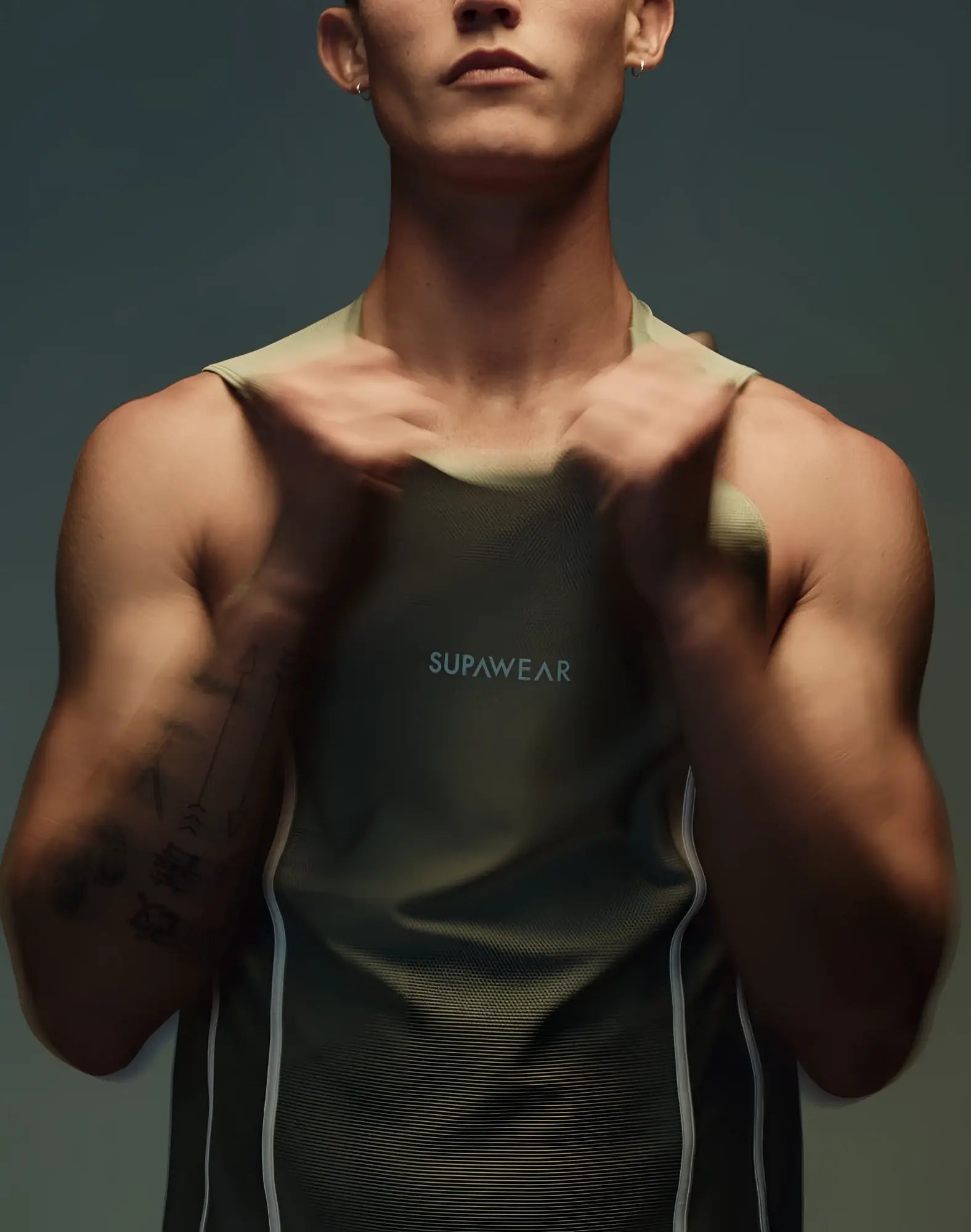 Olive green Supawear Airflow singlet tank top with white side panels and subtle chest logo for activewear use