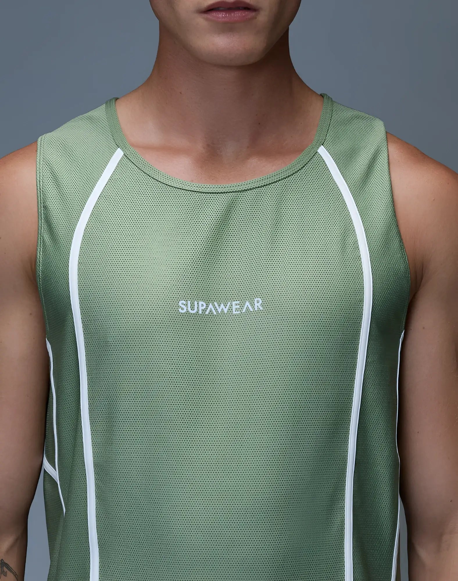 A sage green supawear airflow singlet with white mesh panels and a subtle logo for athletic use