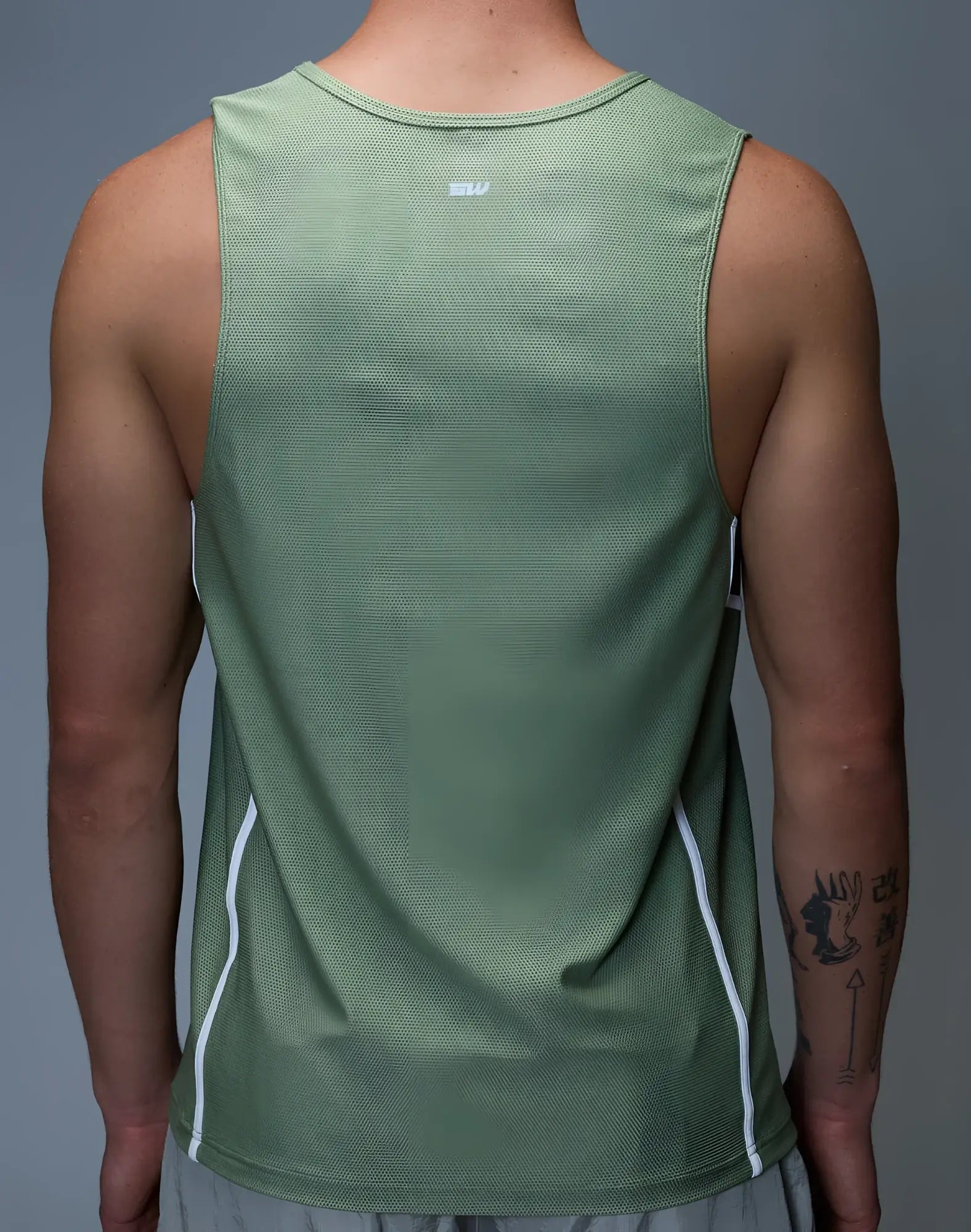 SupaWear airflow singlet green sage athletic tank top with white side panels and subtle textured fabric