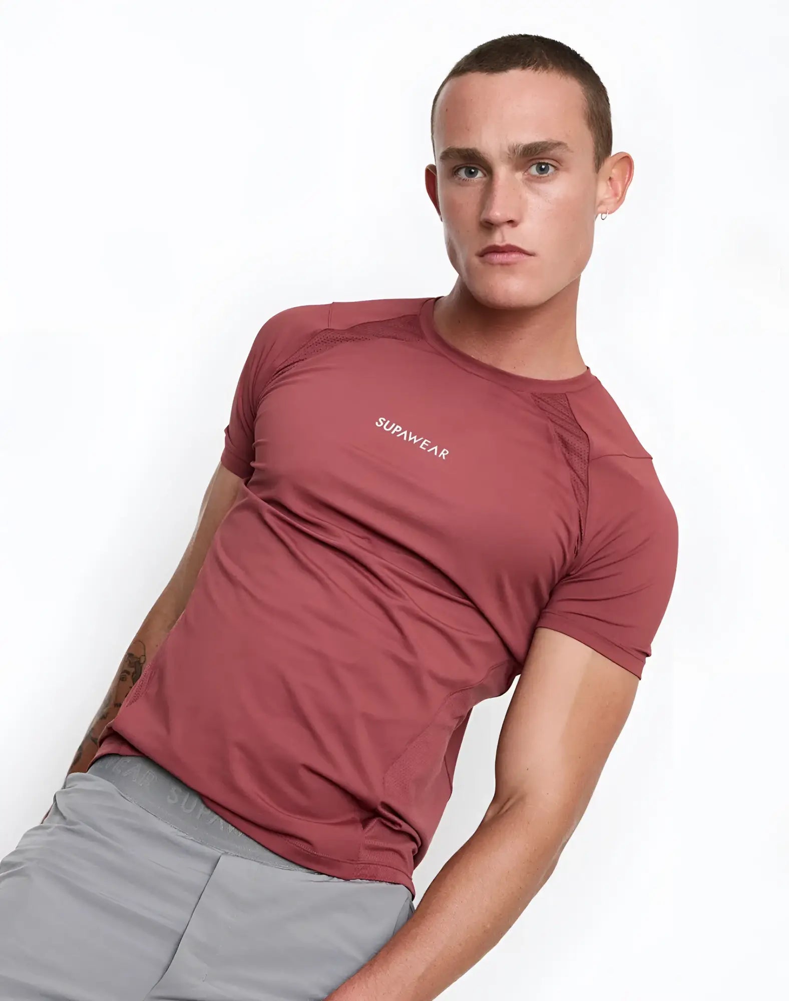 A fitted short-sleeved athletic contouring t-shirt in muted terracotta with supawear logo embroidered on the chest