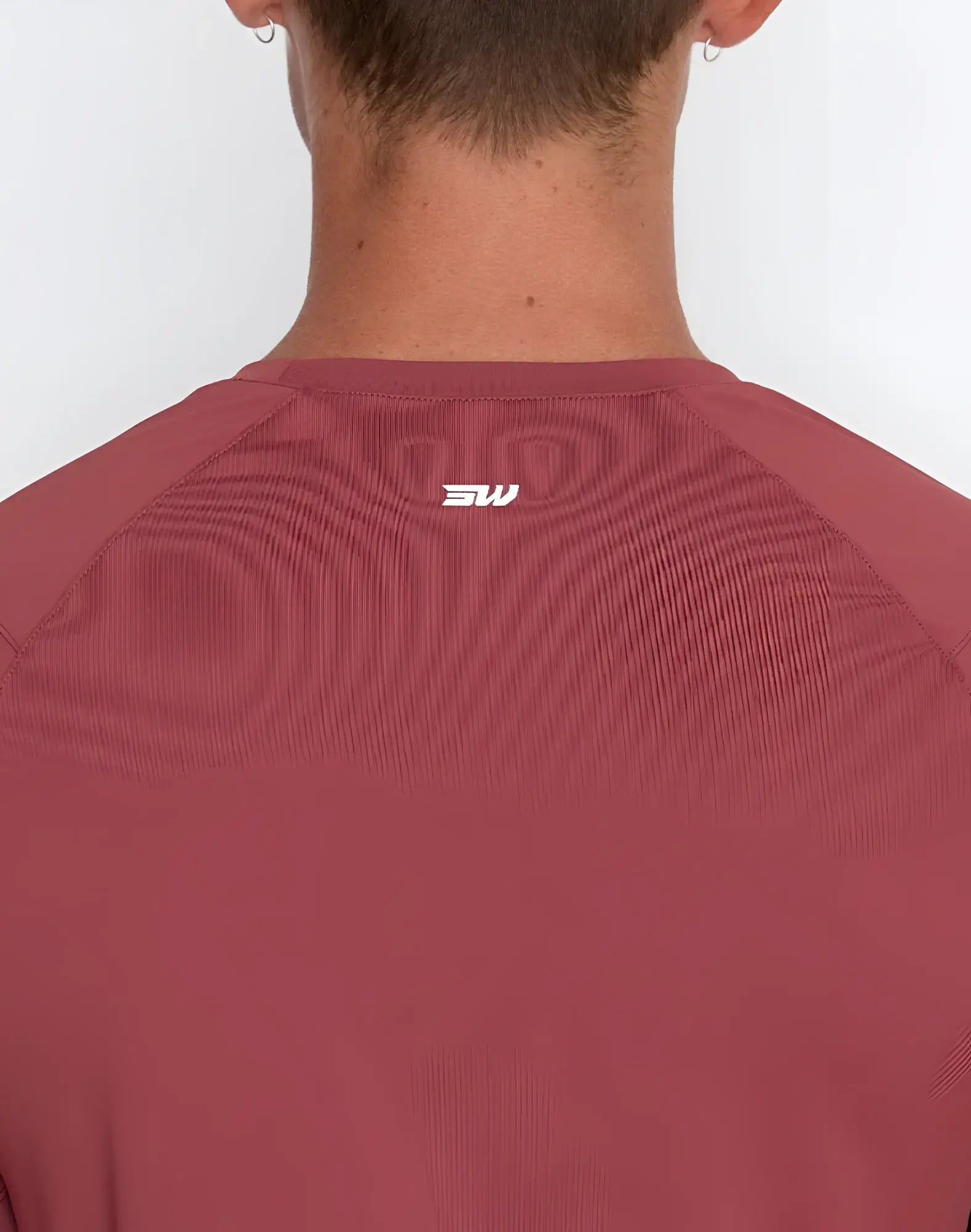SupaWear contouring t-shirt in red with subtle ribbed texture and white sw logo at the neckline