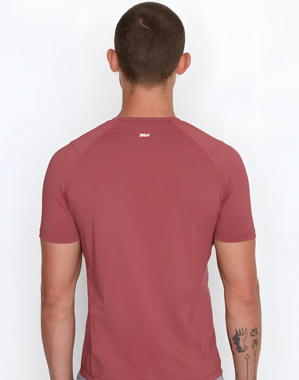 A maroon short-sleeved supawear contouring t-shirt with raglan sleeves and a white logo at the neckline