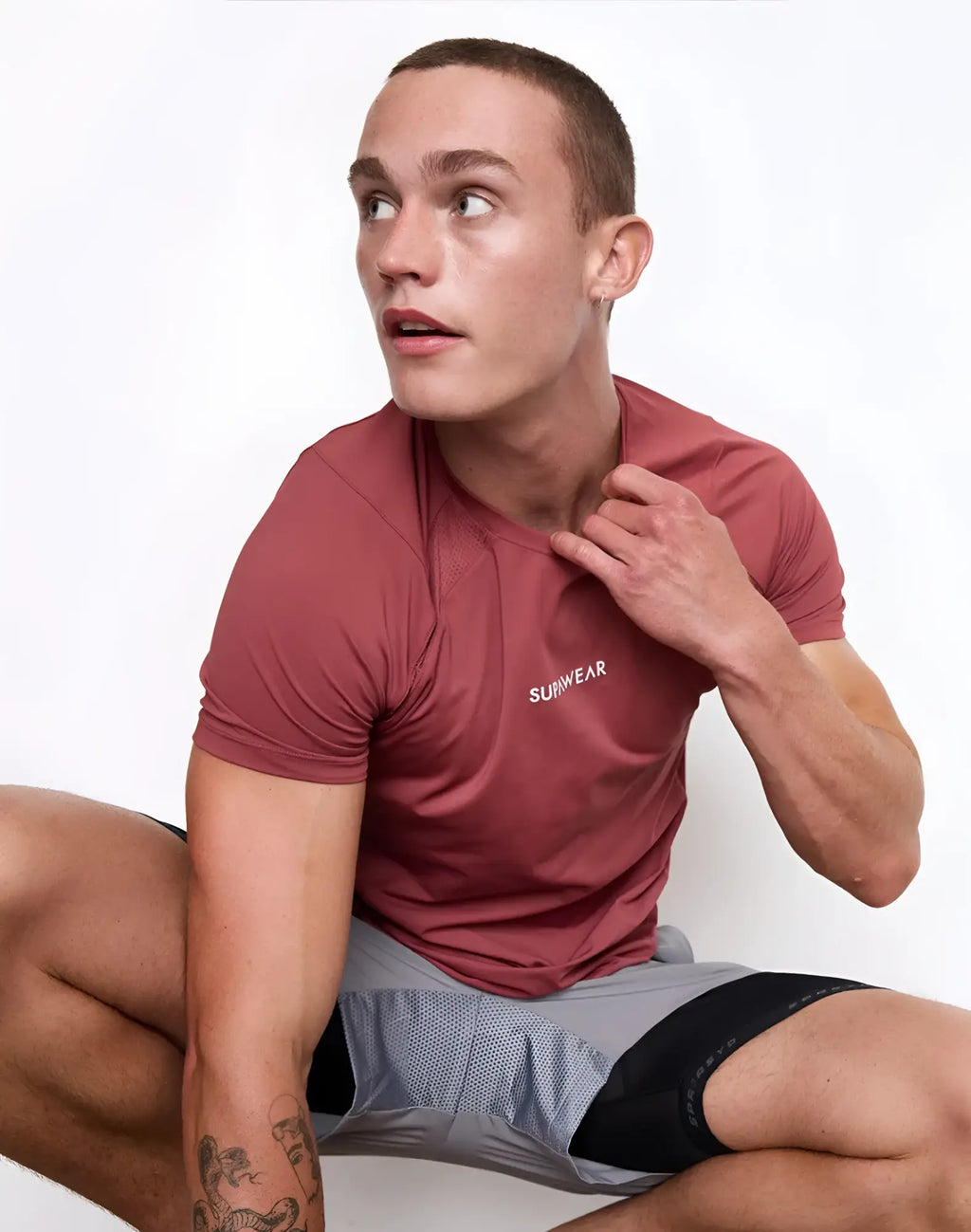 A maroon supawear contouring short-sleeved athletic shirt with a subtle surfwear logo on the chest