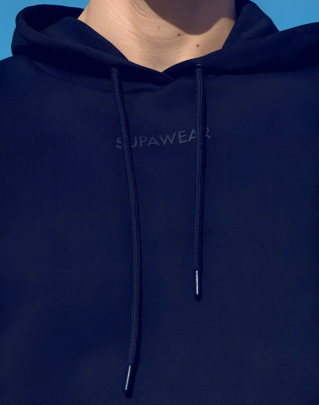 Navy blue Supawear cropped hoodie with matching drawstrings and subtle brand logo on the chest in black material