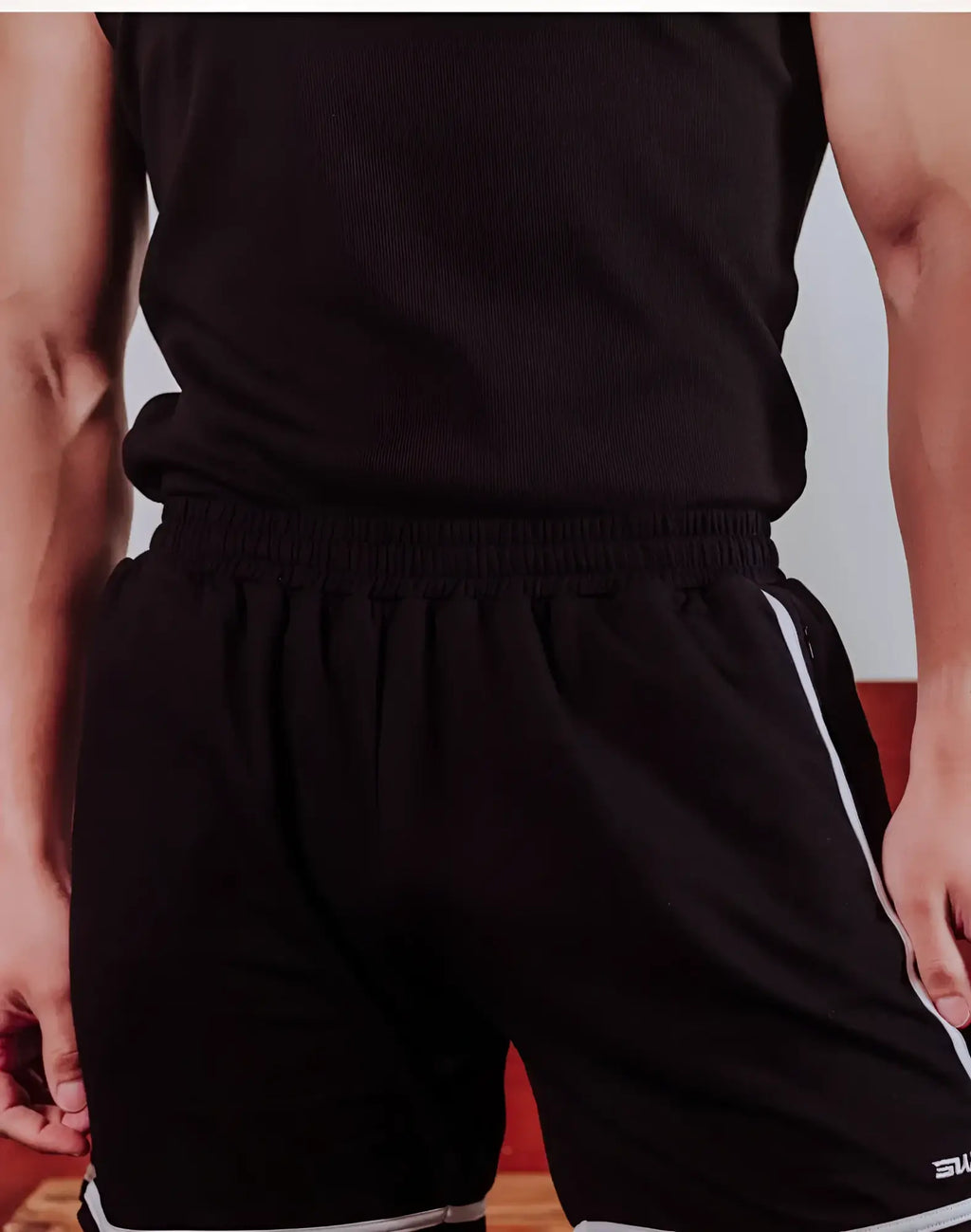 Black supawear crux shorts with white side stripes and a small logo on the lower right leg for athletic use