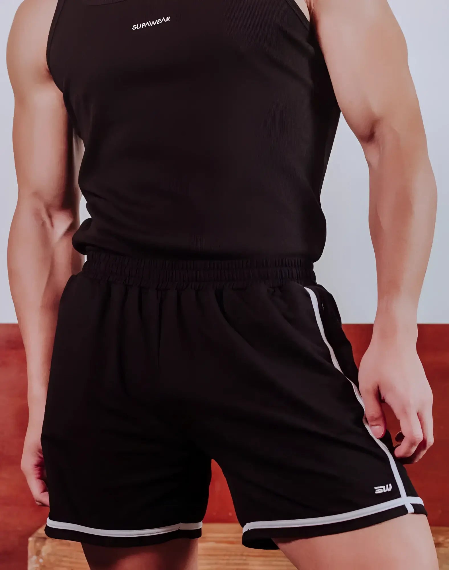 Black supawear crux athletic shorts with white side stripes hem trim and branded logo on waistband