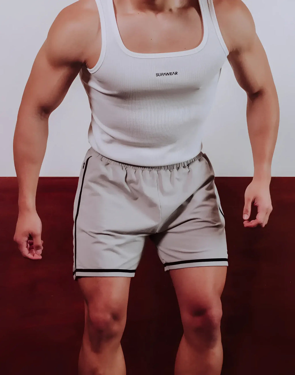 A pair of supawear crux athletic shorts in light gray with black side stripes and elastic waistband for training