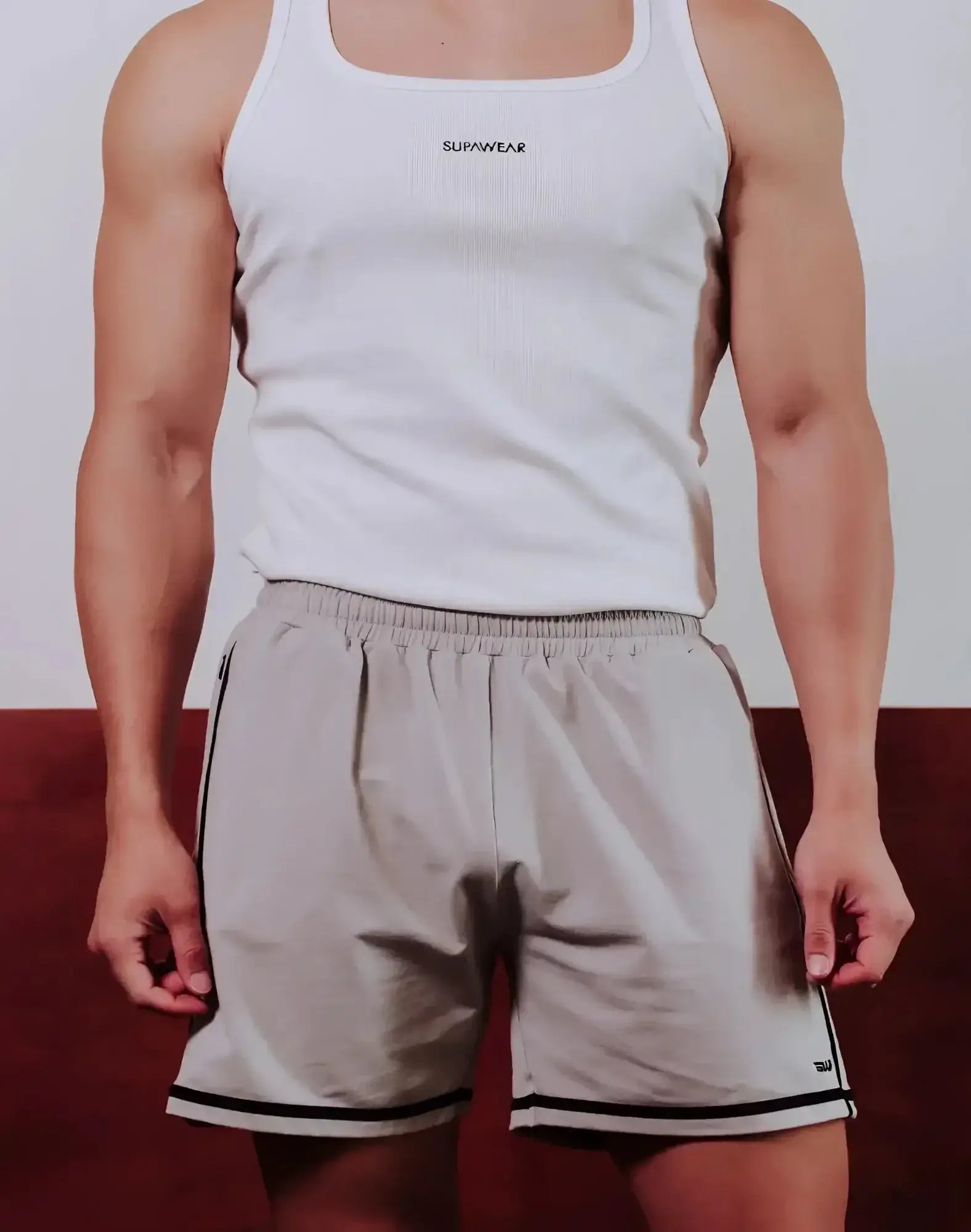 White ribbed tank top with supawear logo across the chest paired with grey supawear crux shorts
