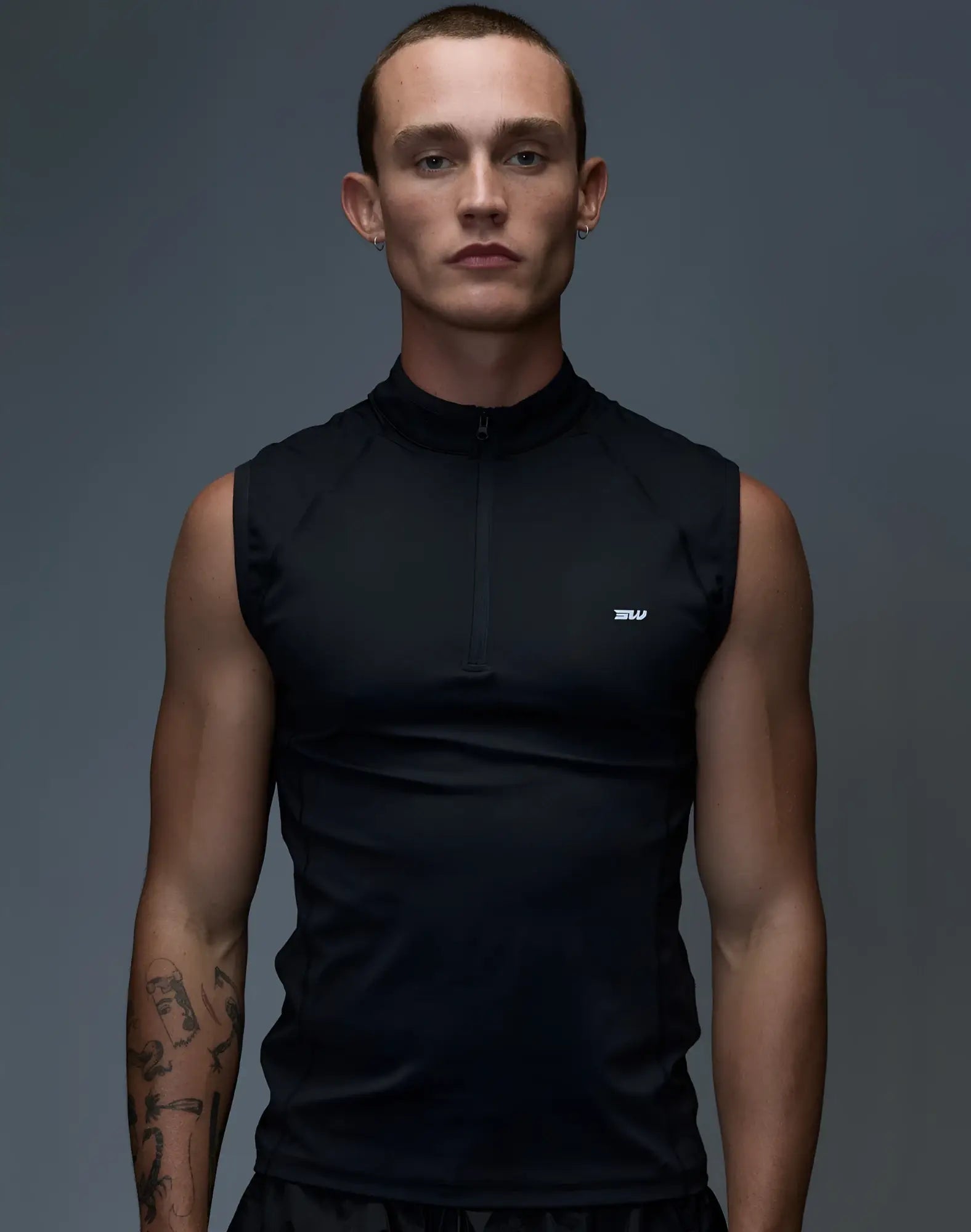 SupaWear gym2street black sleeveless athletic top with half-zip collar and subtle white logo on chest
