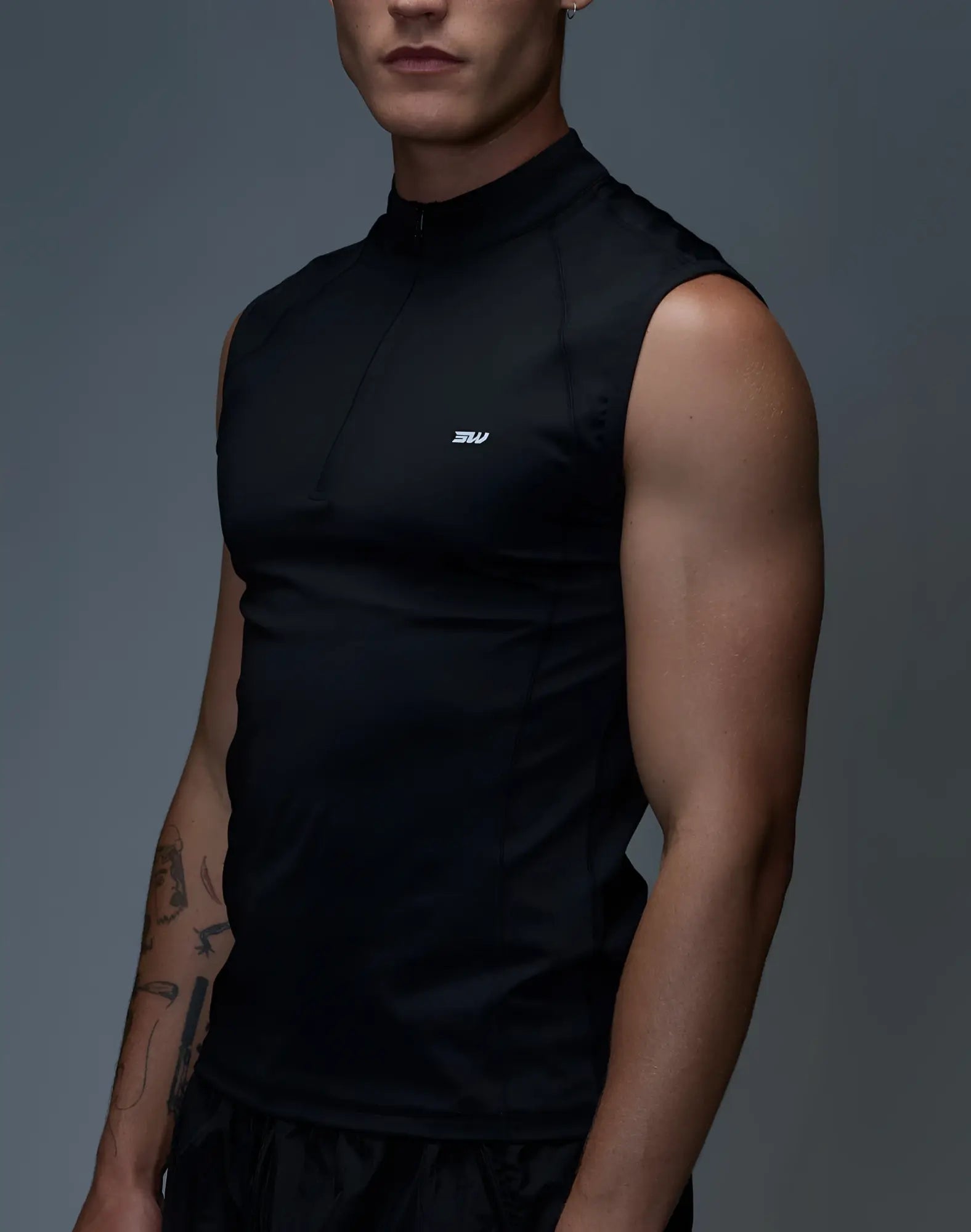 SupaWear Gym2Street black sleeveless half-zip vest with high collar and small white logo on the chest