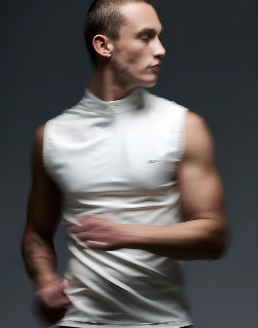 A sleek white sleeveless high-neck sleeveless athletic top with smooth form-fitting fabric from SUPAWEAR Gym2Street