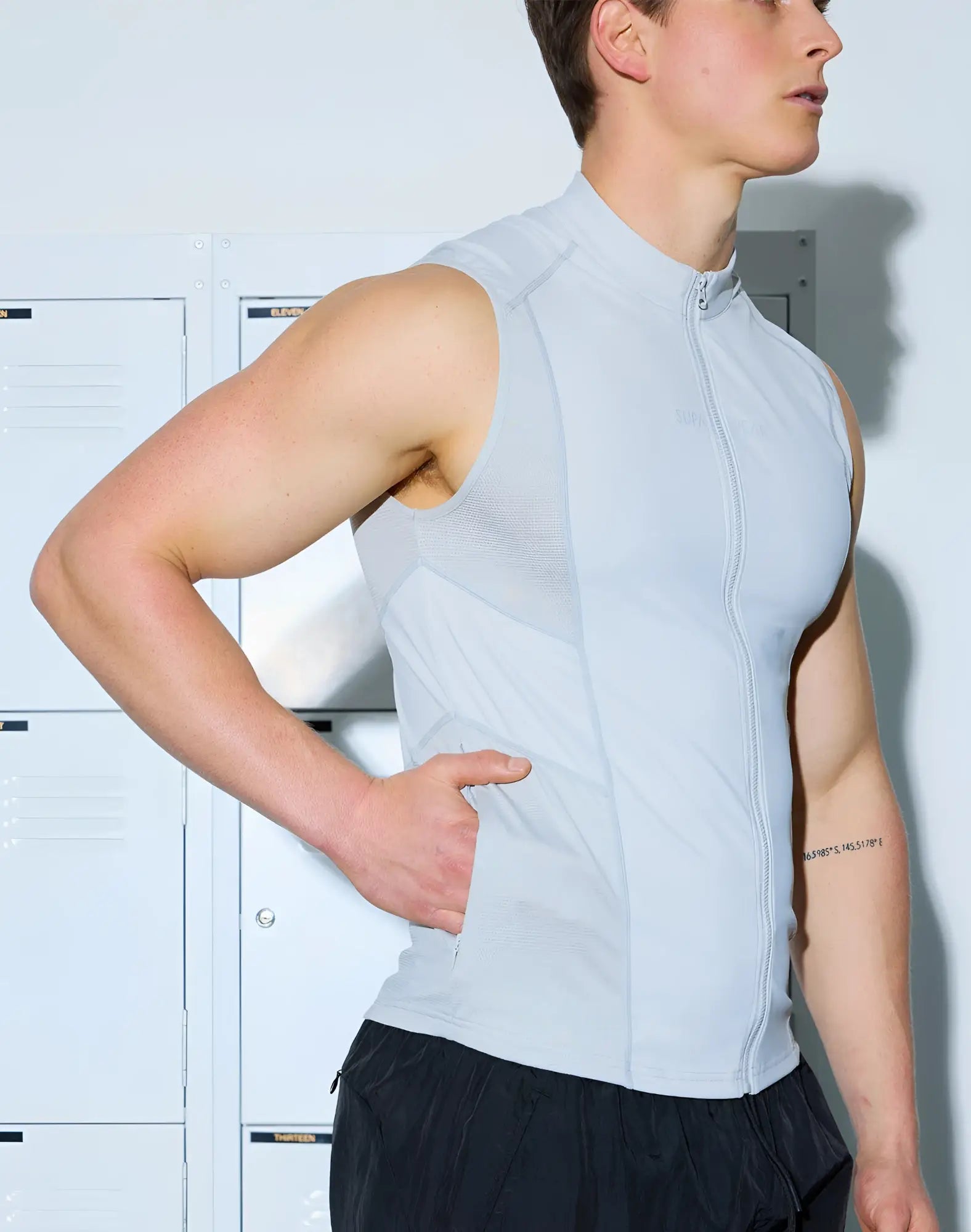 Light blue sleeveless zip-up athletic vest with high collar and mesh panels from SUPAWEAR Gym2Street collection