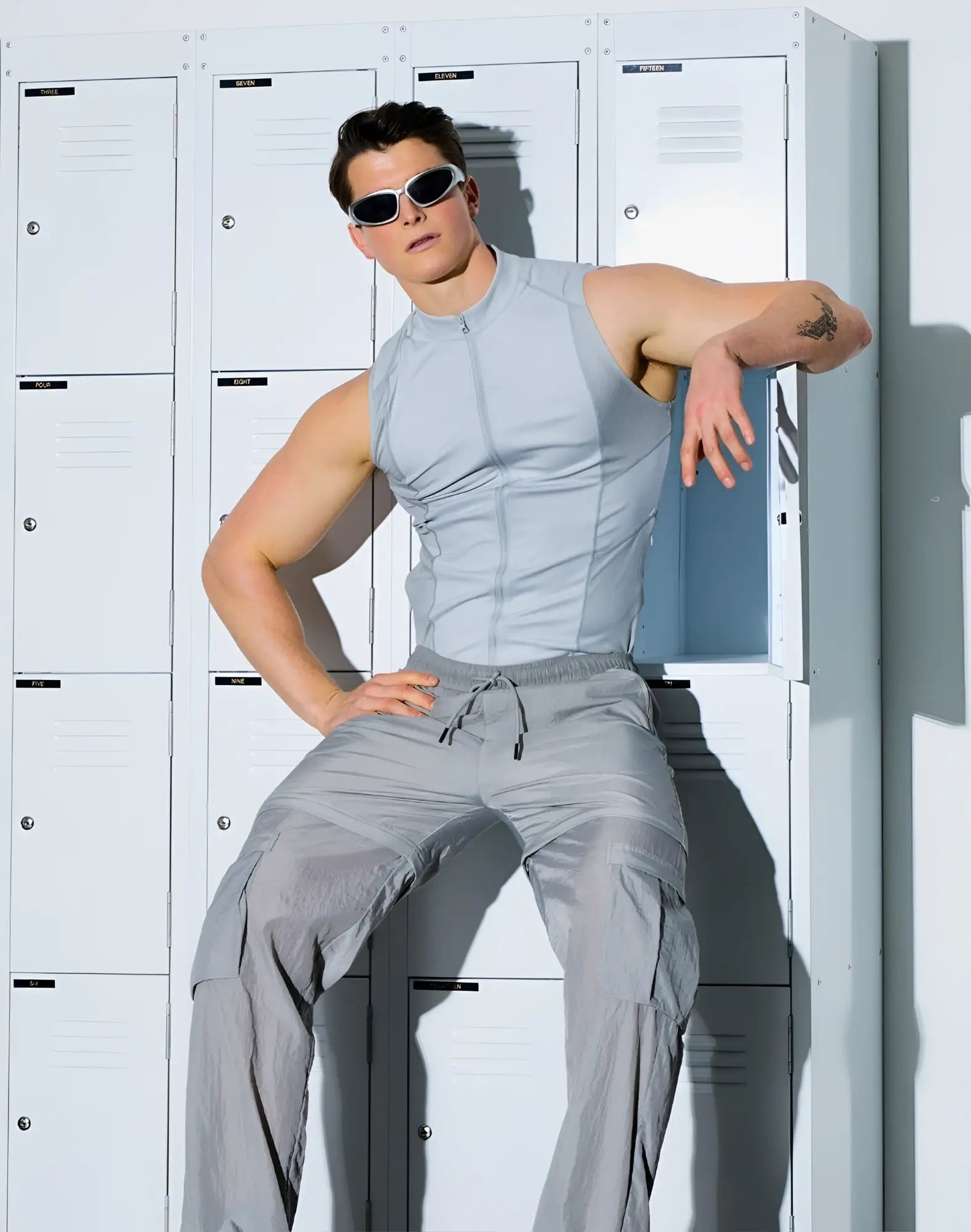 A sleek light gray sleeveless SUPAWEAR Gym2Street zip-up vest with front zipper and structured seams for athletic use
