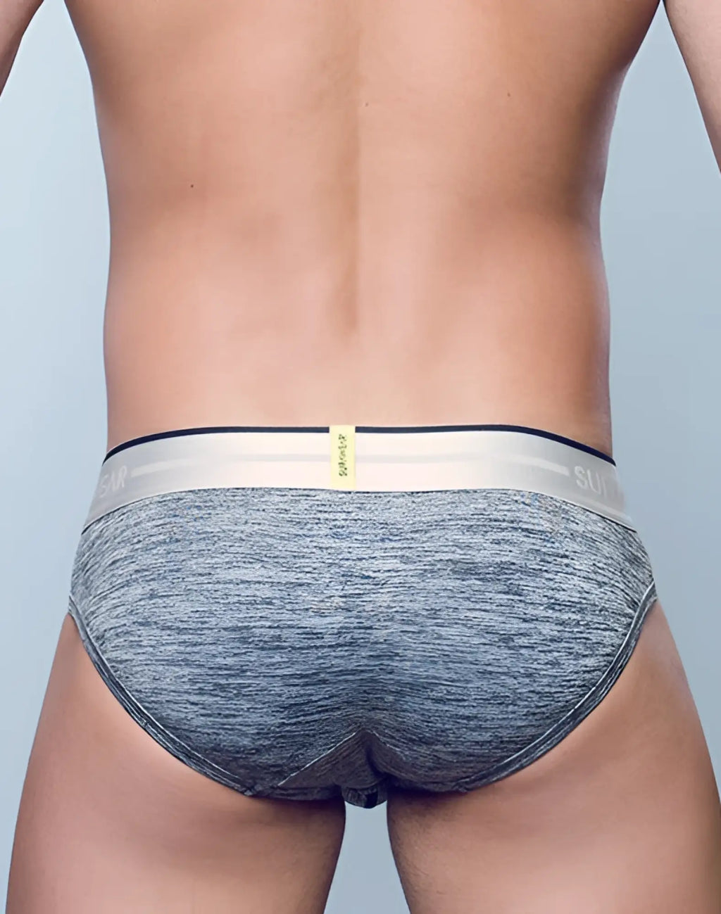 Gray heathered supawear hero brief underwear with white waistband black sui logo and small yellow tag visible