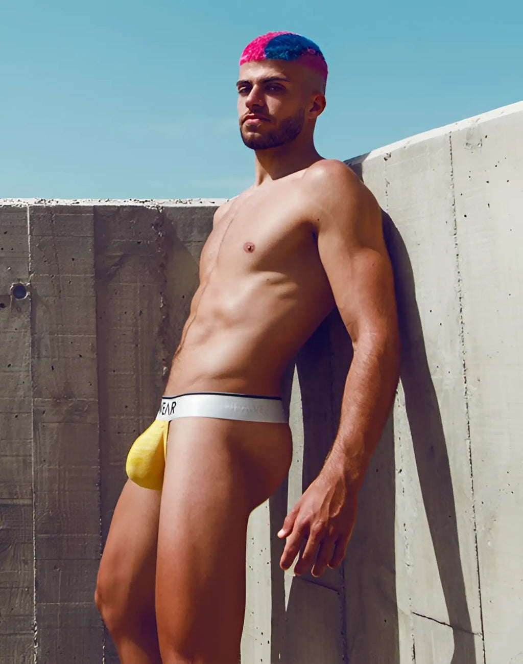 Yellow SUPAWEAR Hero thong athletic briefs with white waistband featuring black gear lettering for active wear