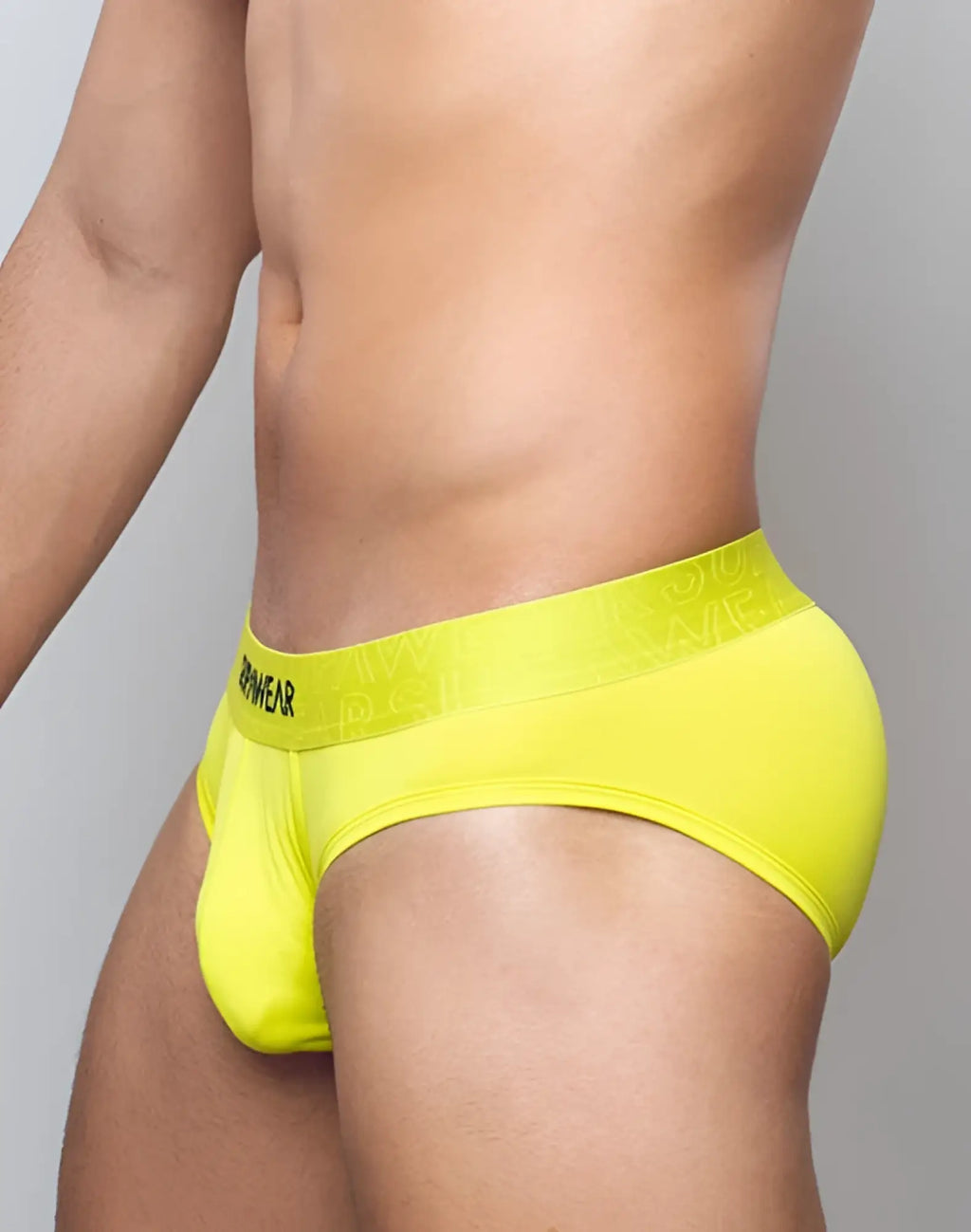 Bright yellow SUPAWEAR neon brief underwear with matching black armywear waistband for men