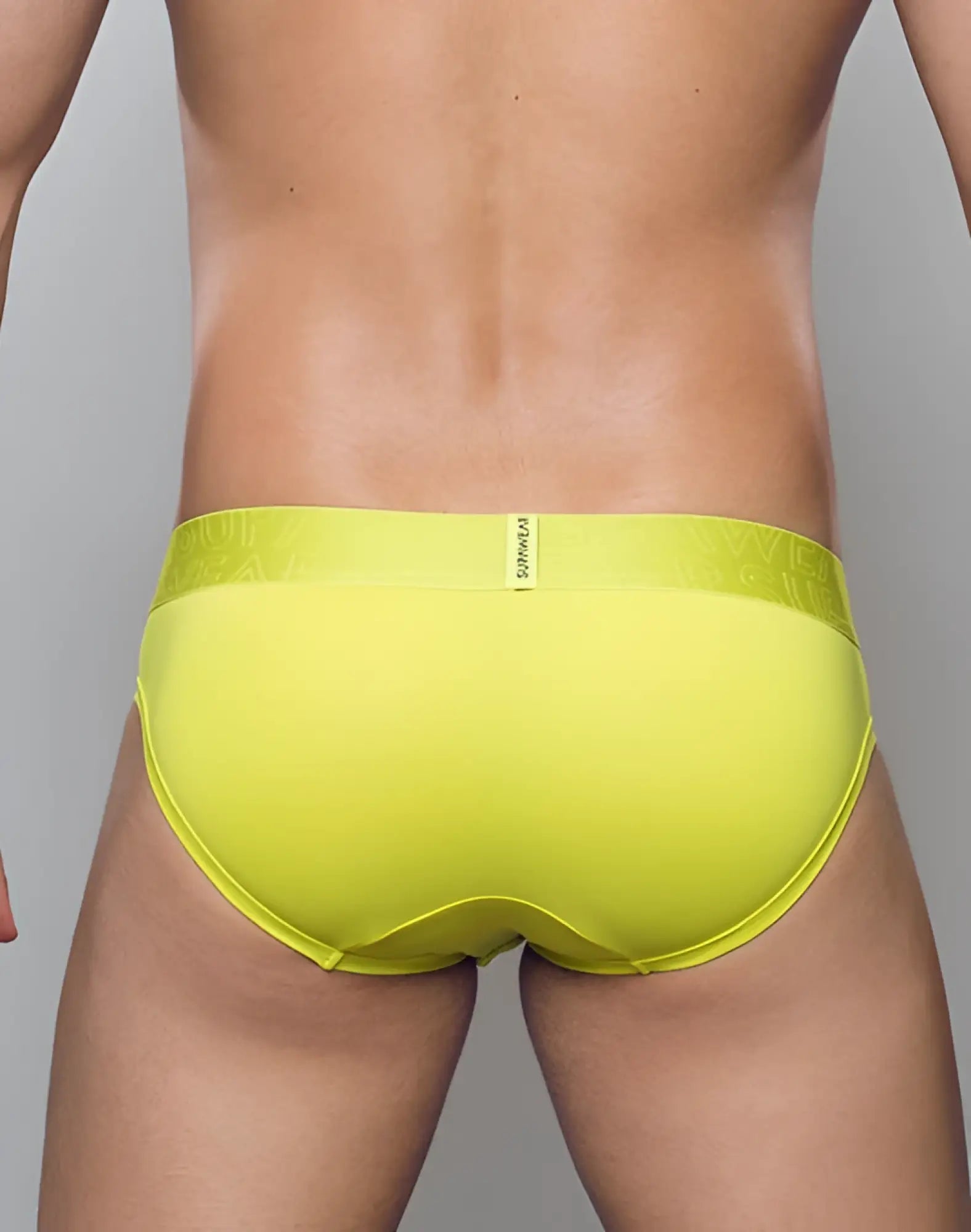 SupaWear neon brief underwear in cyber lime with bright yellow fabric and subtle embossed logo on waistband