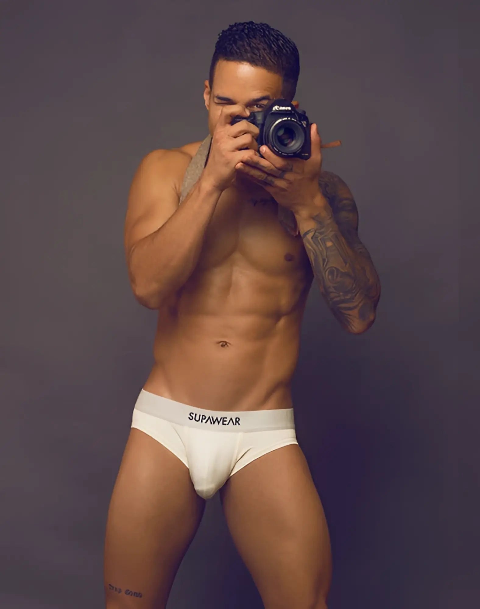 Ivory supawear neon brief underwear with white fabric and black supawear logo on the waistband front side