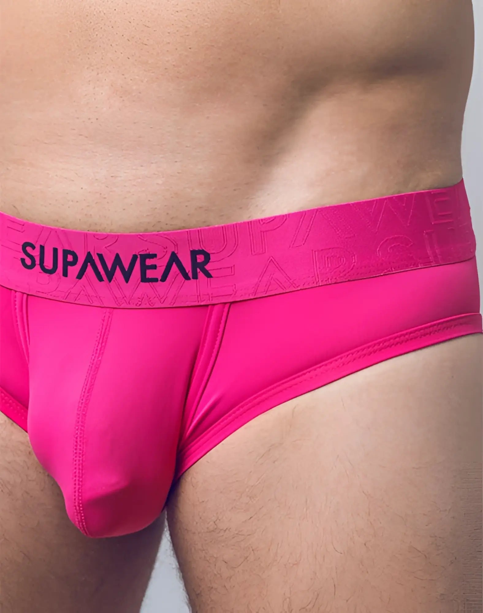 Neon pink supawear briefs with matching elastic waistband featuring black supawear branding in front view