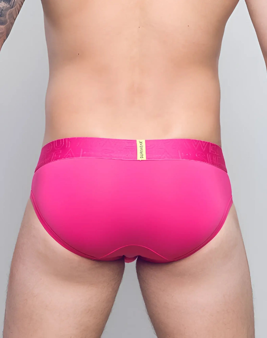 Bright pink supawear neon brief underwear with matching elastic waistband and gold sunfire branding