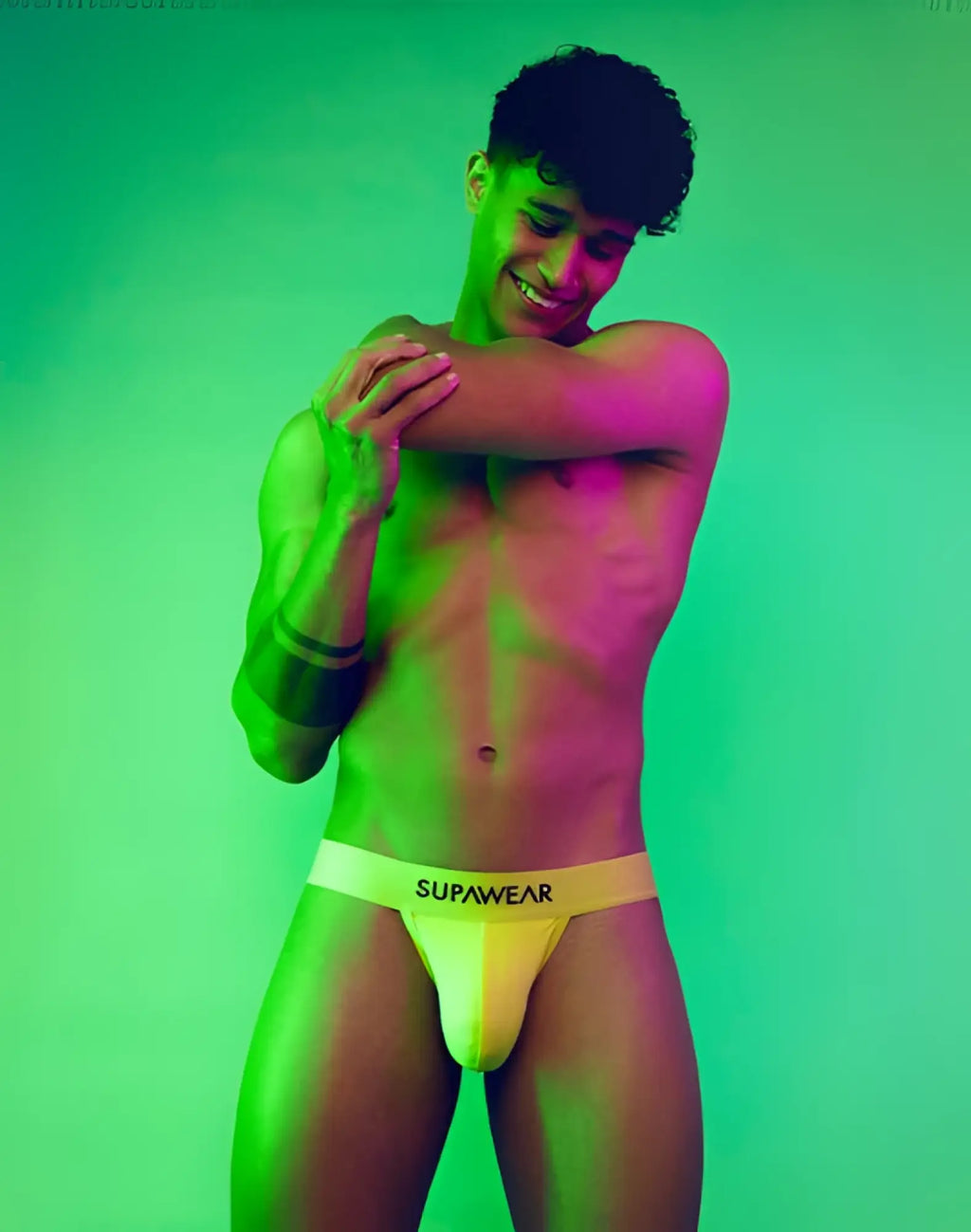 Yellow supawear briefs with white waistband and black brand name lettering from supawear neon jockstrap underwear cyber lime collection