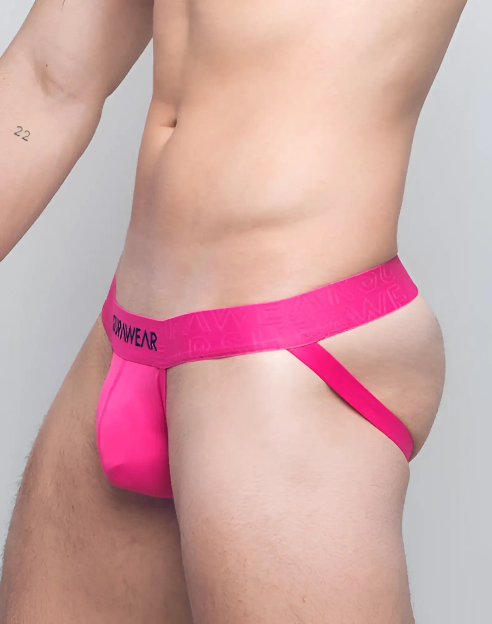 Bright pink seamless SUPAWEAR neon jockstrap briefs with matching waistband featuring drawwear logo in black lettering