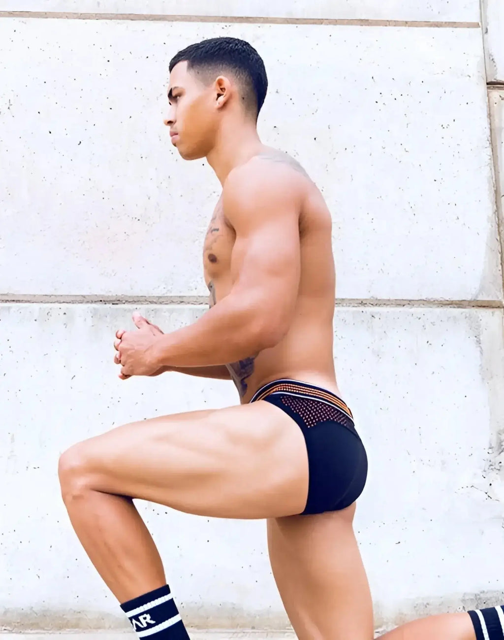 Black briefs with neon orange trim and breathable mesh panel from supawear neon mesh brief underwear collection