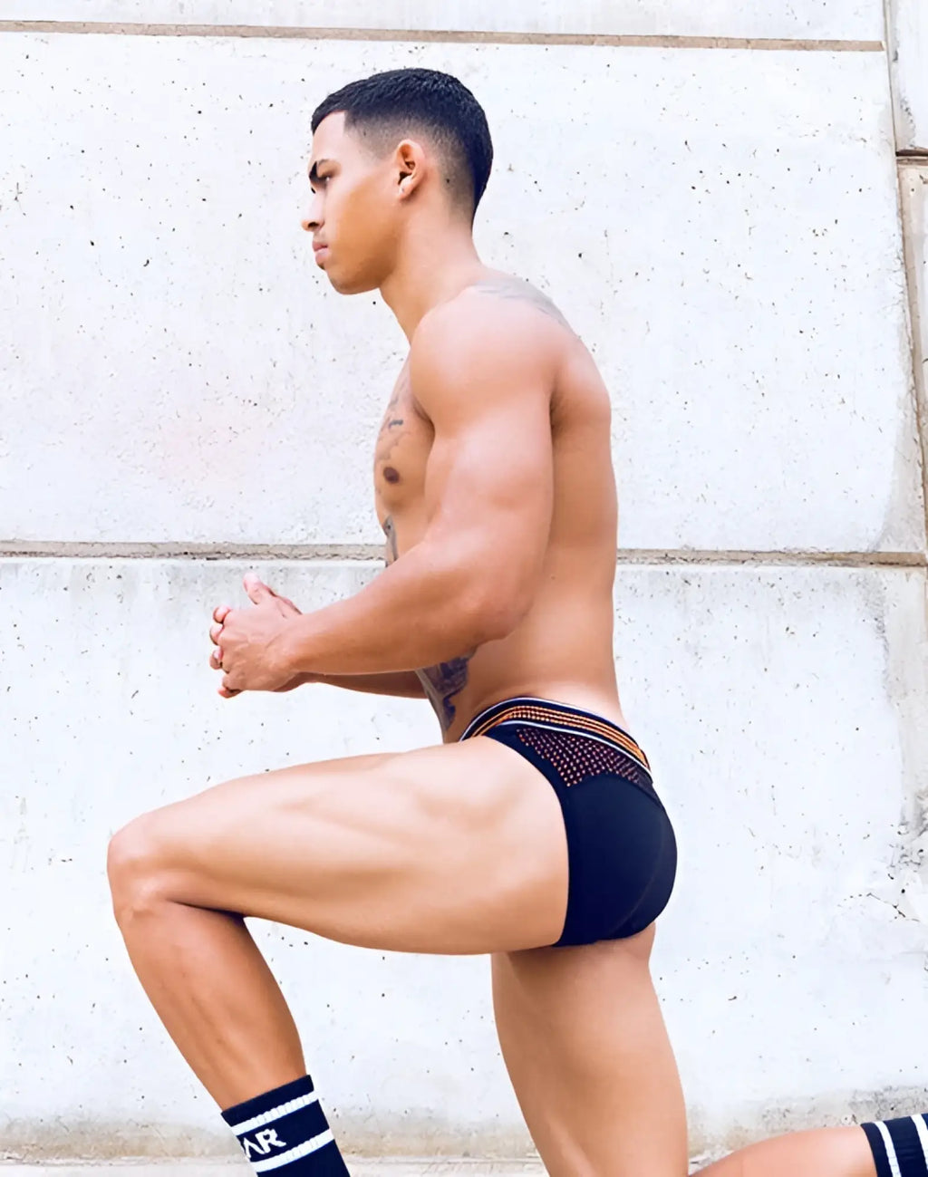 Black briefs with neon orange trim and breathable mesh panel from supawear neon mesh brief underwear collection